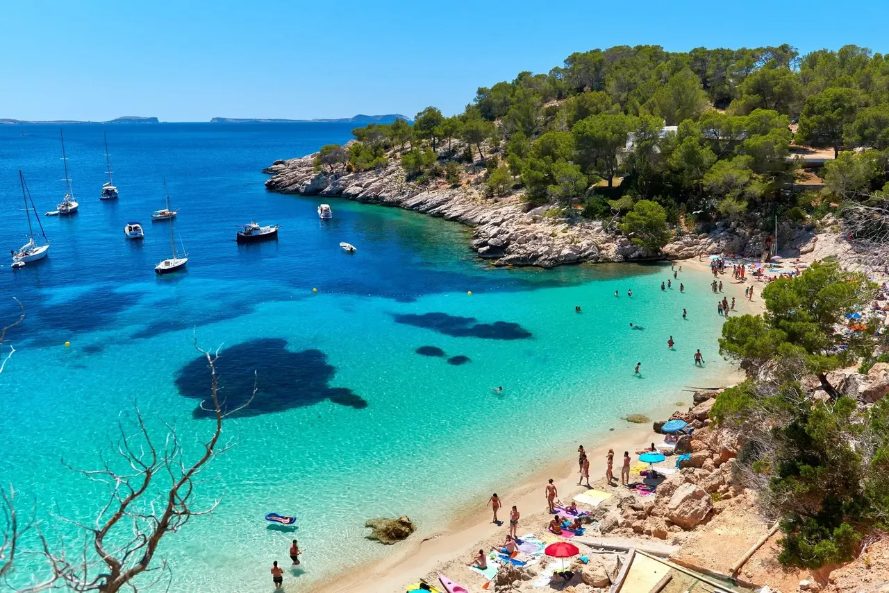 Personas disfrutando de sus vacaciones en la laguna Cala Salada. Paisaje idílico. Ibiza, Islas Baleares. España
