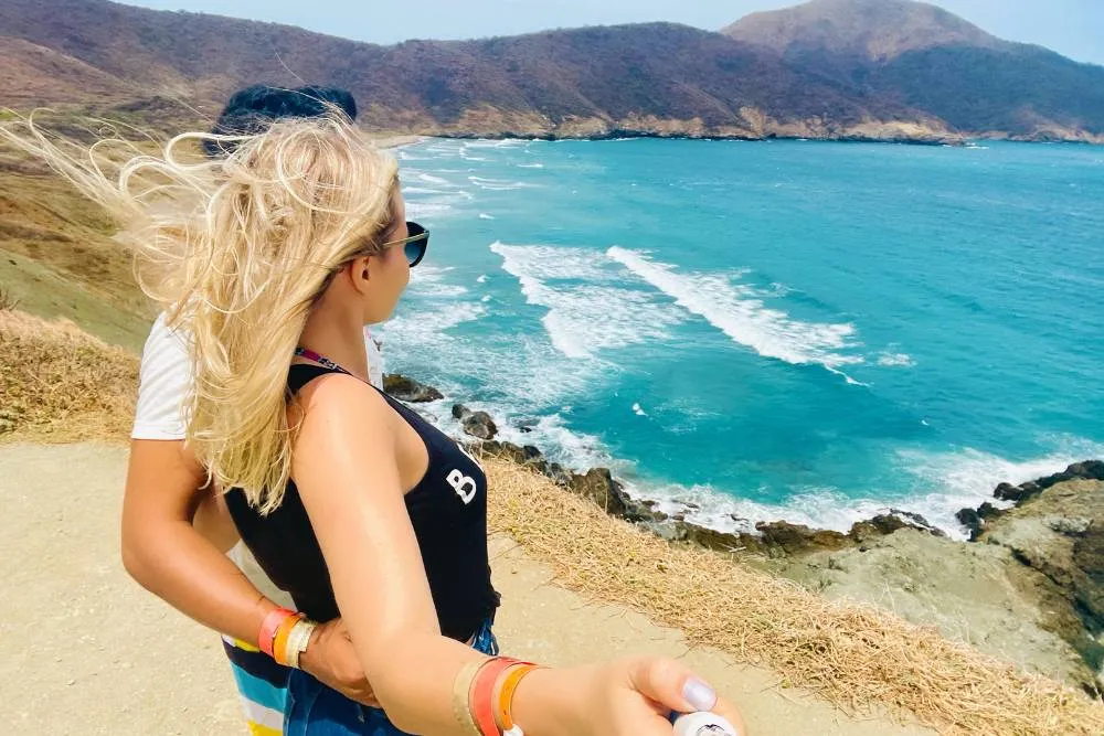 Young couple taking photo with selfie stick on the coast in Santa Marta — Getty Images