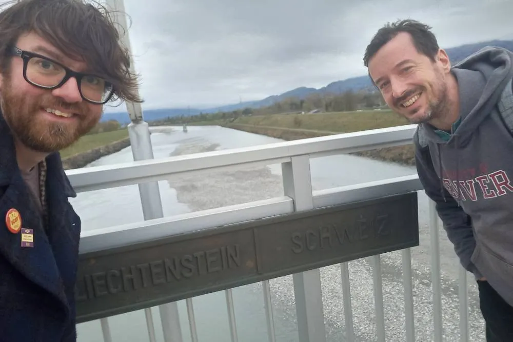 David and Joe on bridge next to Liechtenstein-Swizterland border sign — David Szmidt