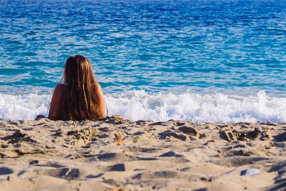 Woman lying on the beach at Psili Ammos — Shutterstock
