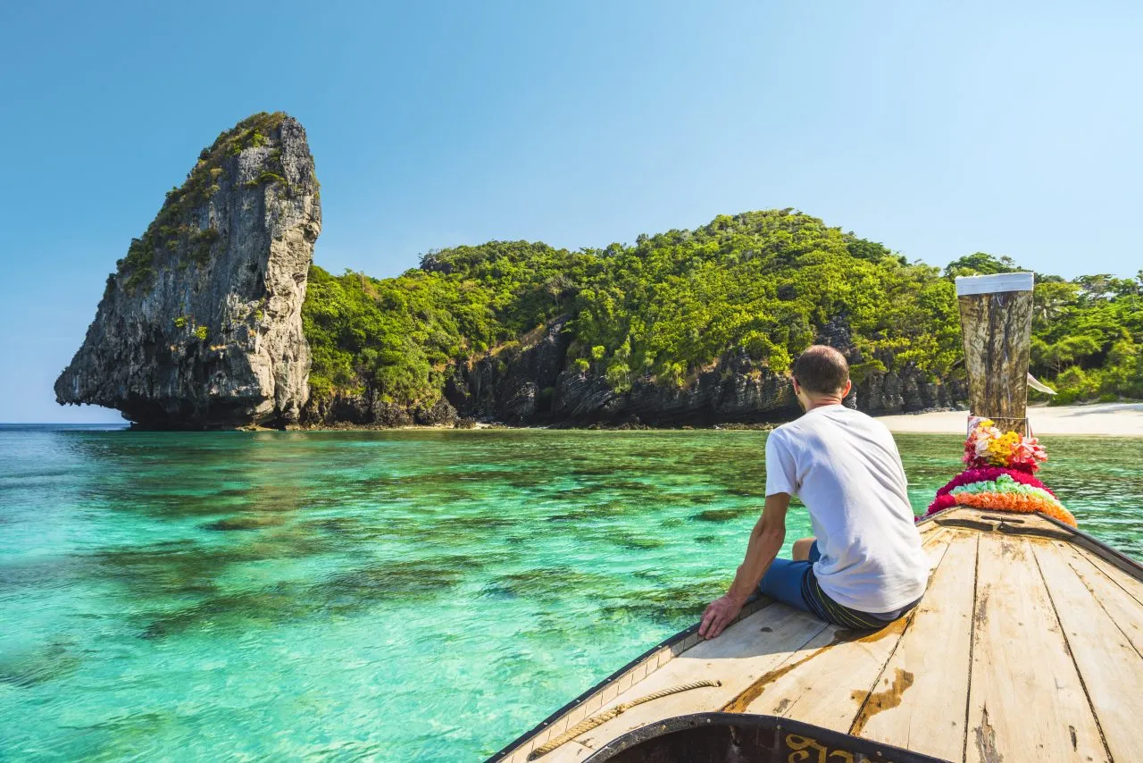 Tourist sitting on a longtail boat in Phi Phi Island, Thailand