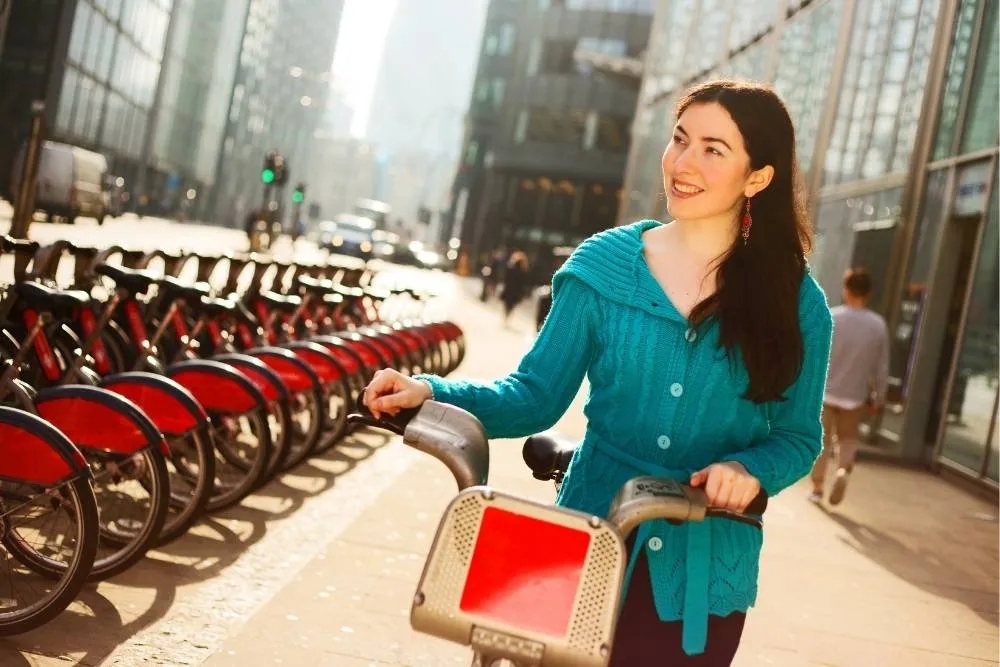 Woman strolling with a hired street bike in London — Shutterstock