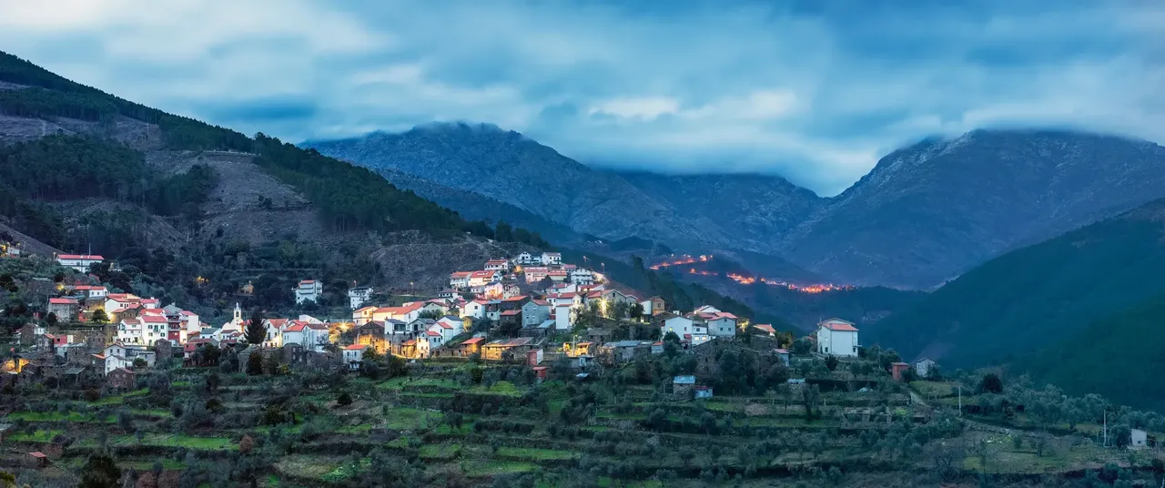 Distant aerial view of Cabeça, Seia, Portugal, a quaint village surrounded by rugged landscapes and festive decorations