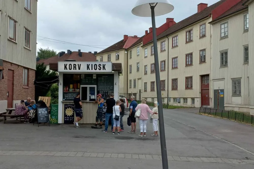 People queuing outside Swedish hot dog stand — David Szmidt