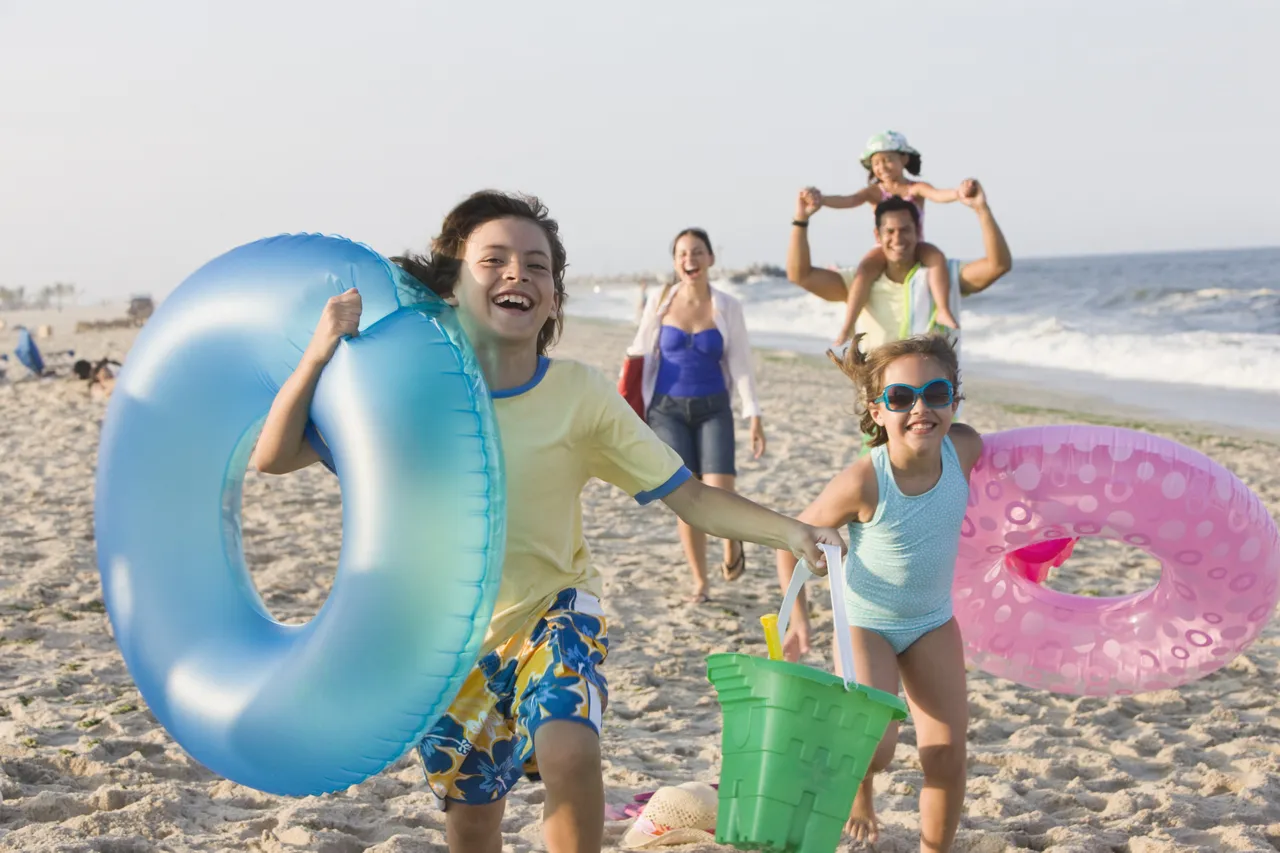 Family with three children enjoying their vacation by the seaside in the USA
