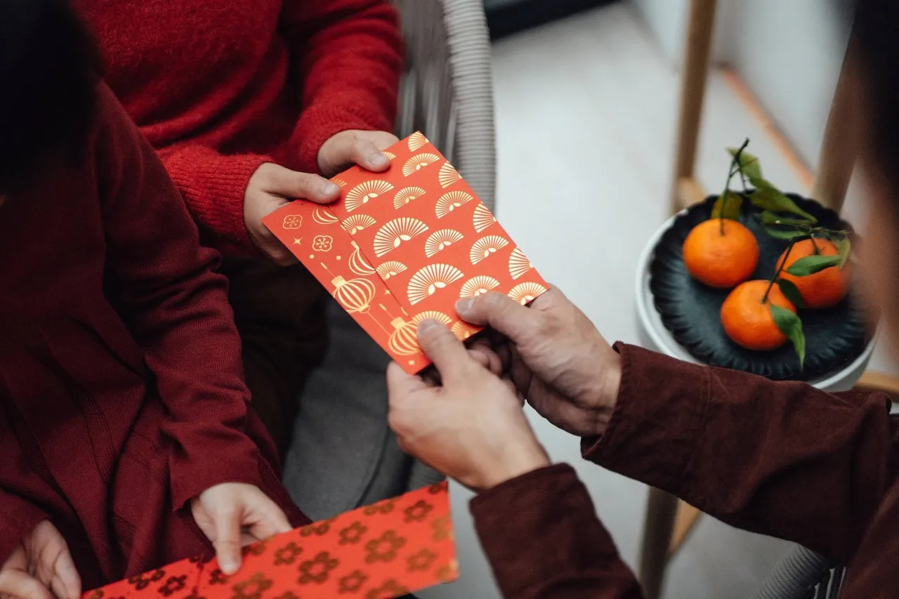 Asian family celebrating Chinese New Year at home. Chinese New Year greetings and wishes for luck.