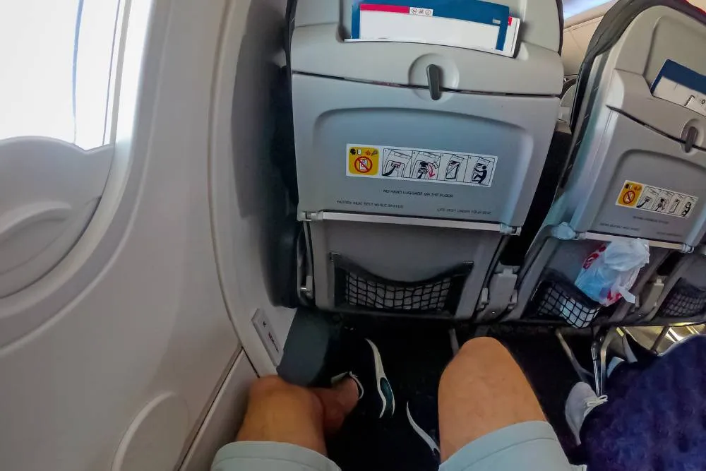 POV shot of sitting in exit row seat on airplane — Getty Images