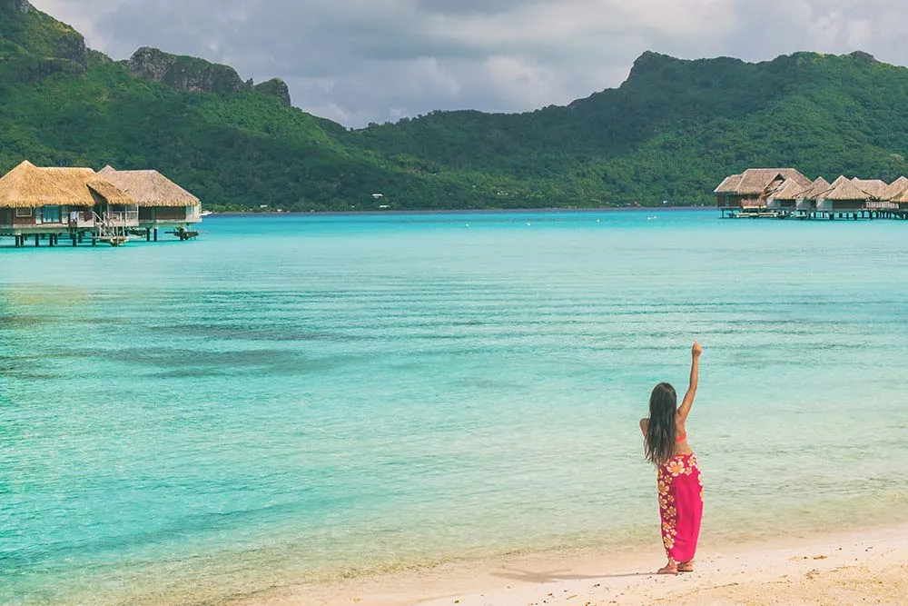 woman standing on a beach in tahiti