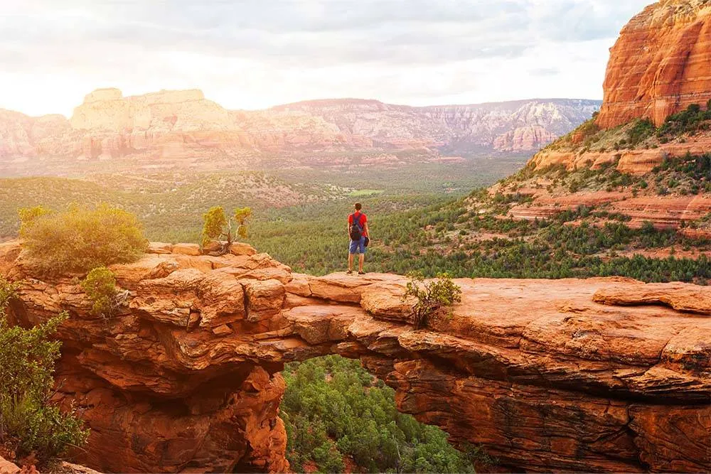 Hiker admiring the view of red rocks in Sedona — Shutterstock