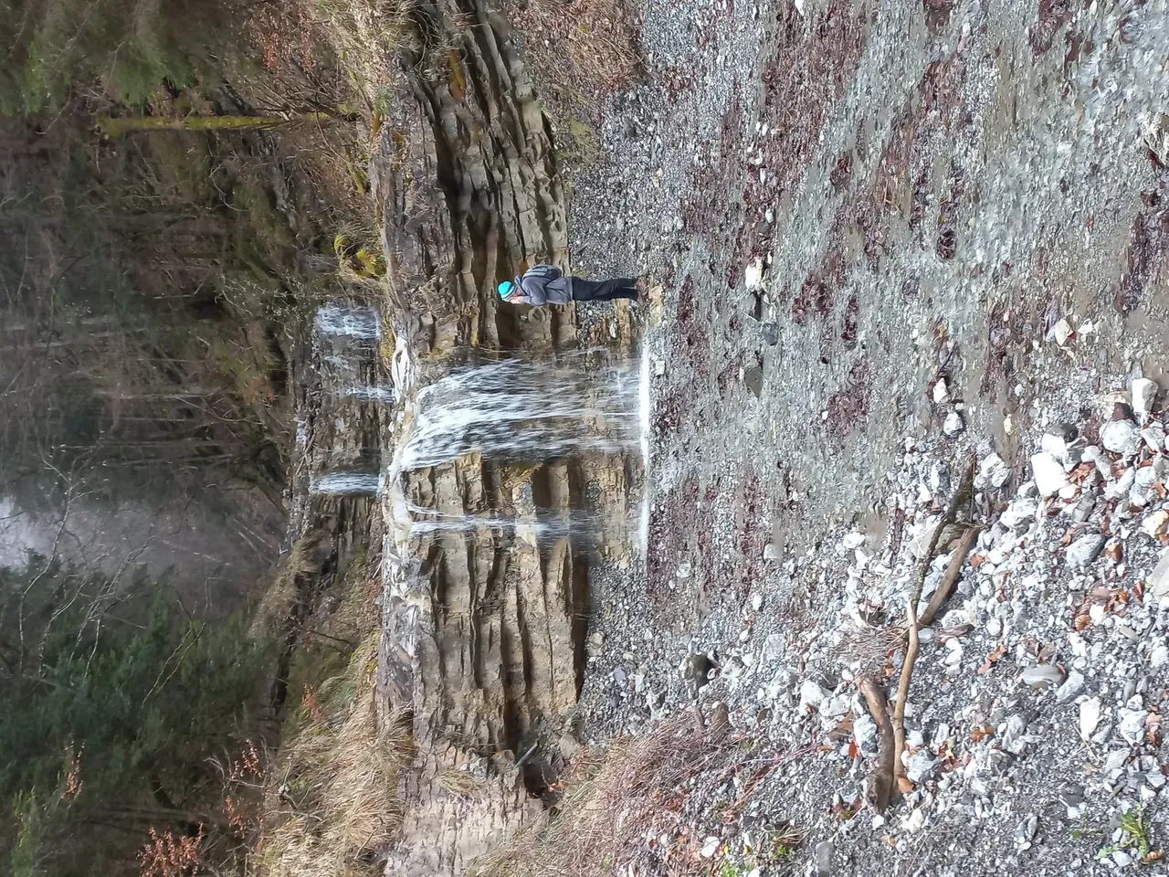 Person standing next to waterfall in Liechtenstein — David Szmidt