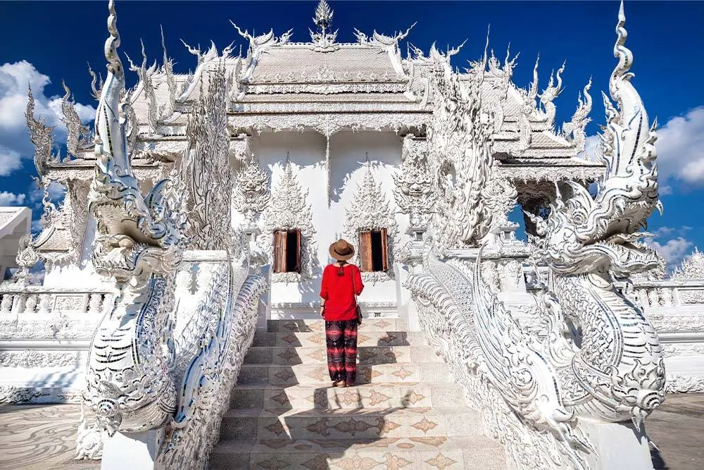 Person stood in front of the White Temple in Chiang Rai — Shutterstock