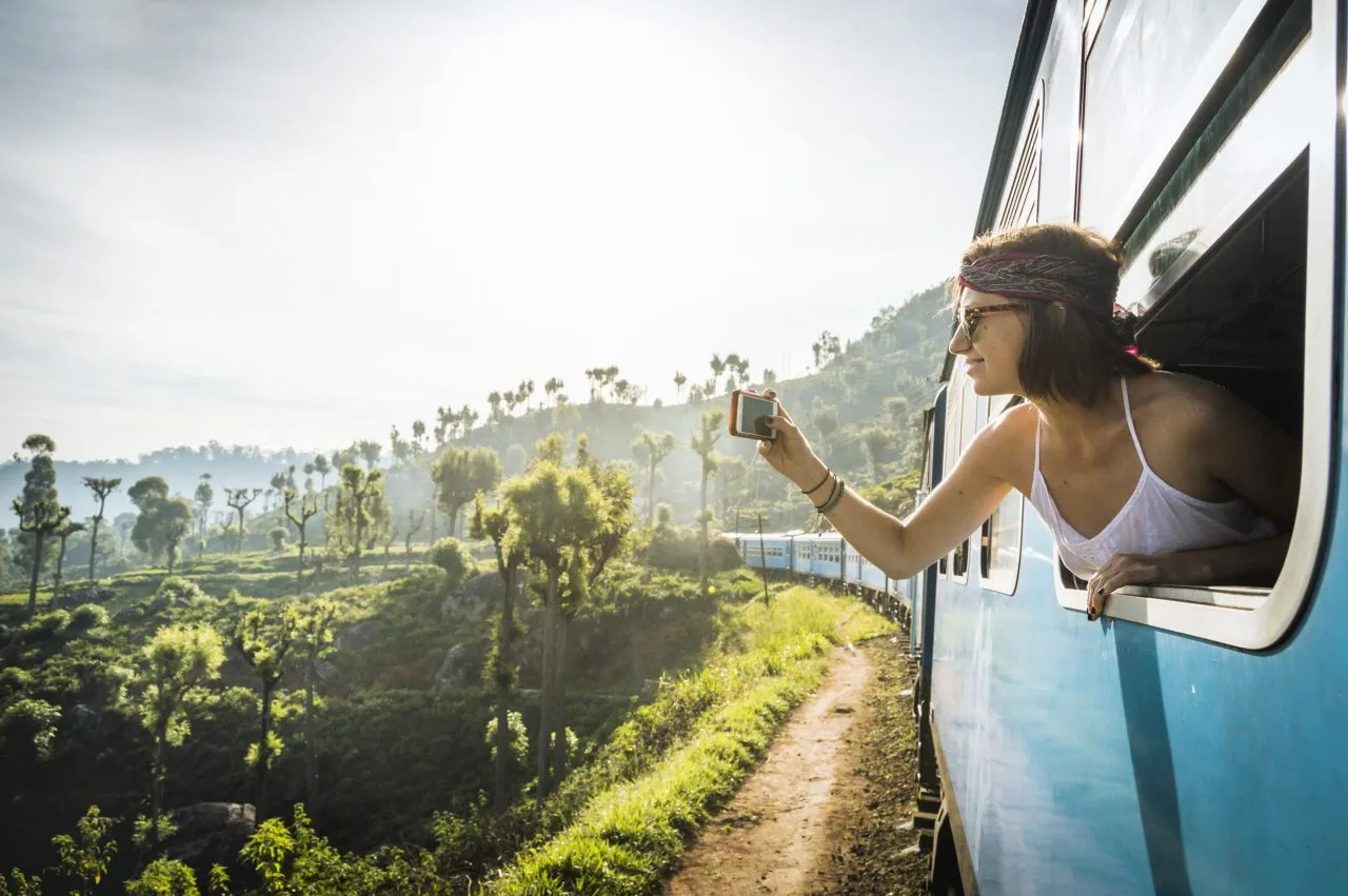 Young woman taking the classic Ella train ride, Sri Lanka
