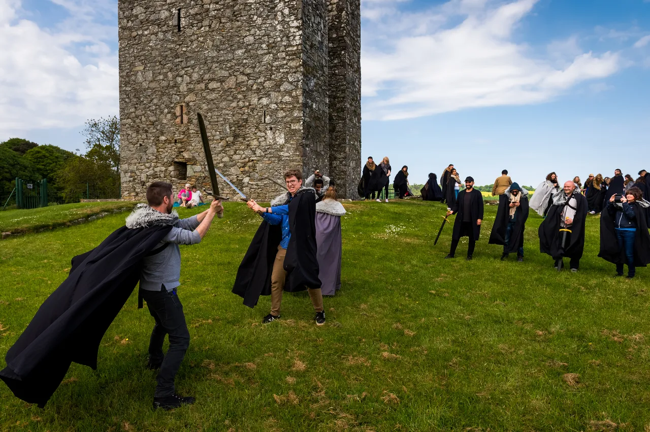 tourists on the themed tour of “Game of Thrones” are experiencing sword fighting in the Castle Ward which is a filming location as Winterfell of “Game of Thrones”.
