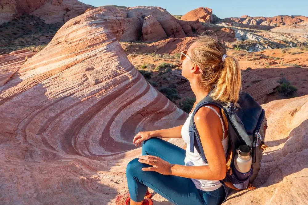 Woman sitting with view of Valley of Fire — Getty Images