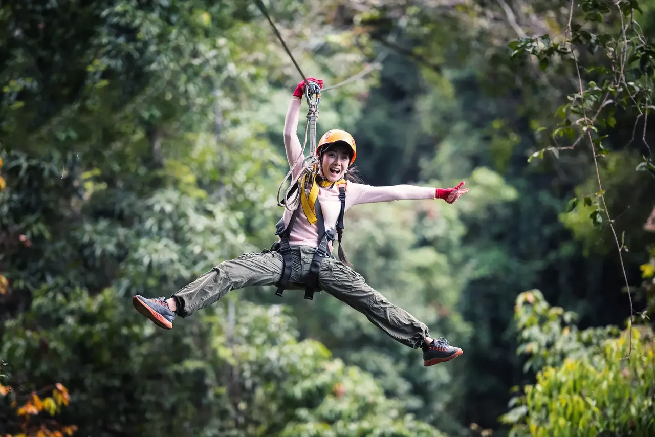 Joyful person on a zip line — Shutterstock