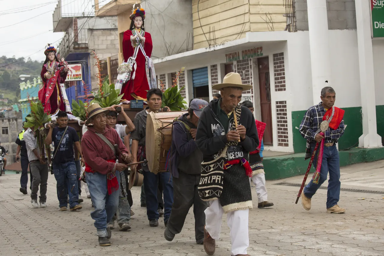 A group of men participate in a procession during the 2014 Day of the Dead festivities in Joyabaj, Guatemala.