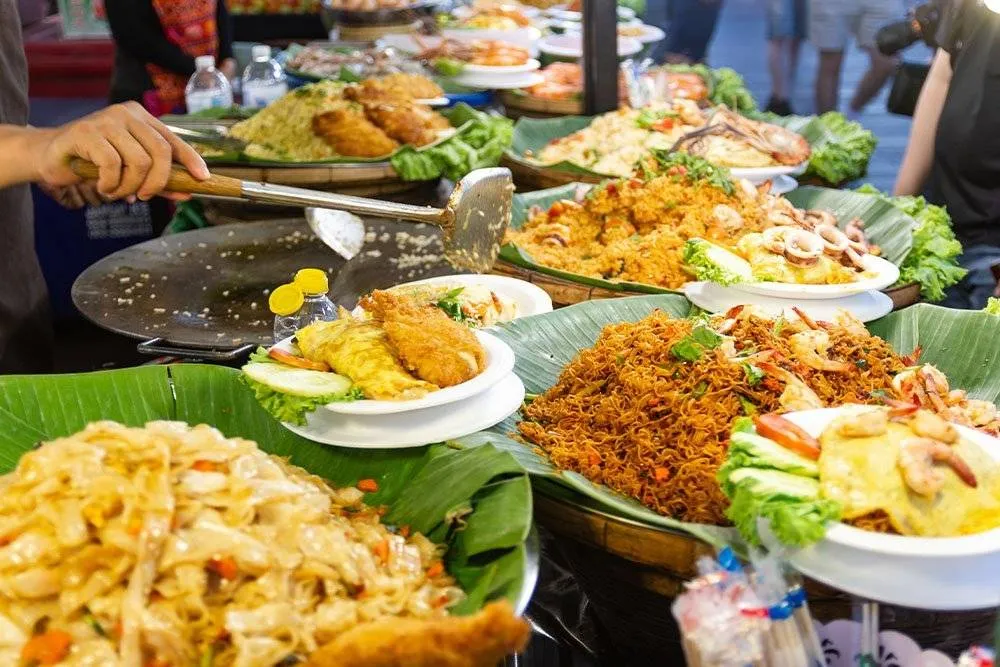 A selection of Thai street food served by a vendor — Shutterstock