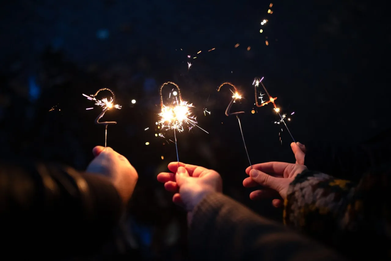 Sparklers Happy new Year 2024 in the hands of one family.