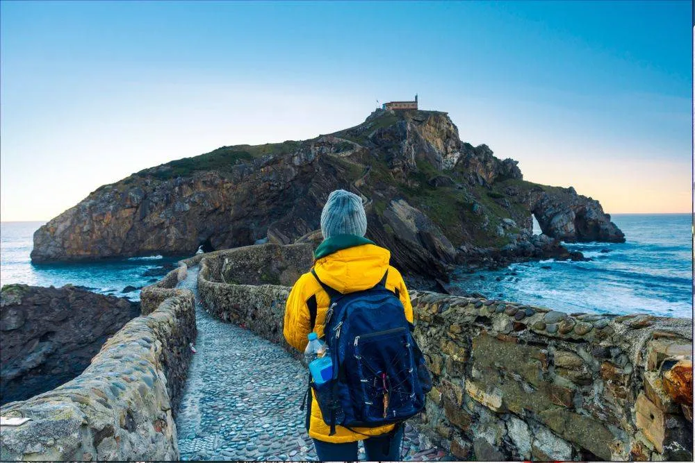 A woman on the road to Gaztelugatxe.