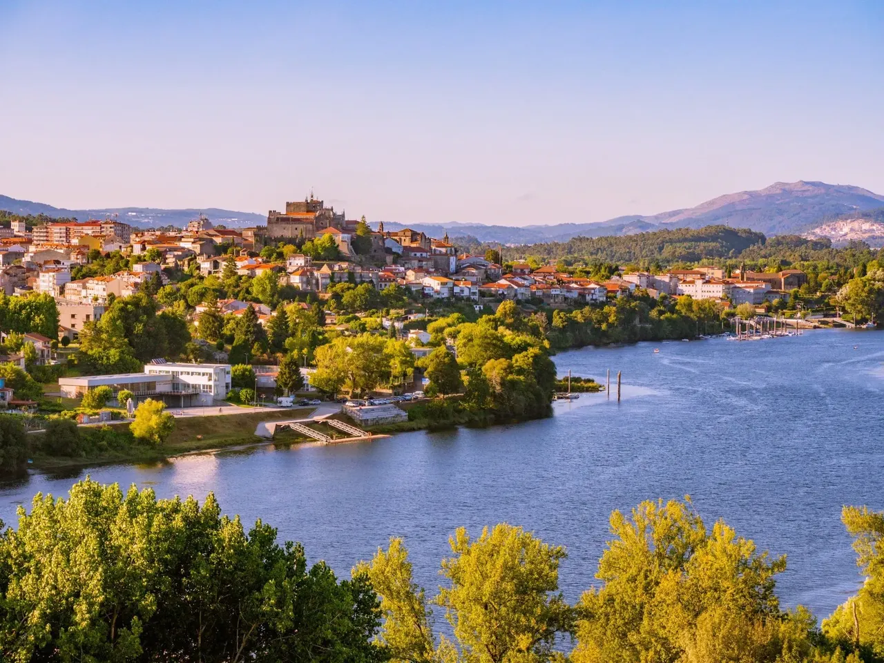 Scenic faraway view of Tui village surrounded by lush greenery along the Camino de Santiago trail
