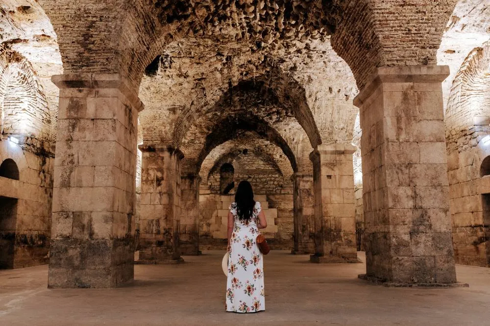 Woman standing in the underground room of Diocletian’s Palace — Getty Images