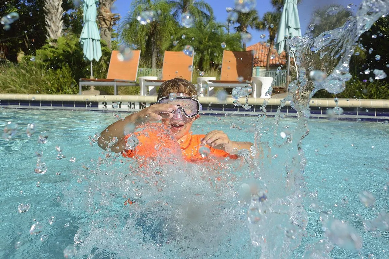 Boy swims in a pool, Orlando, U.S.A