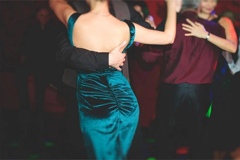 Angled shot of a well-dressed couple dancing a milonga in a ballroom — Shutterstock
