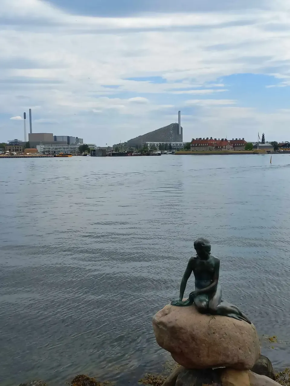 View past The Little Mermaid statue over water — David Szmidt