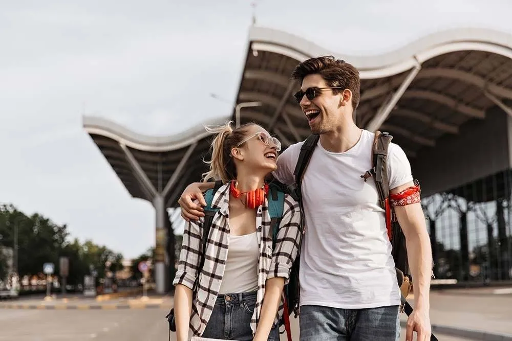Couple laughing outside of an airport