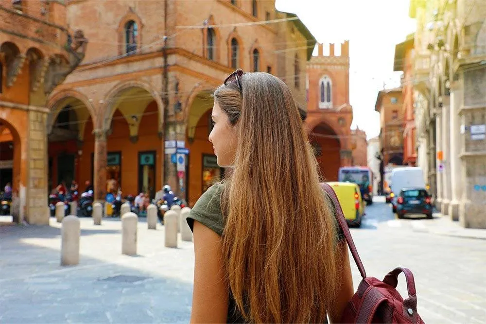 Woman walking in the center of Bologna — Shutterstock