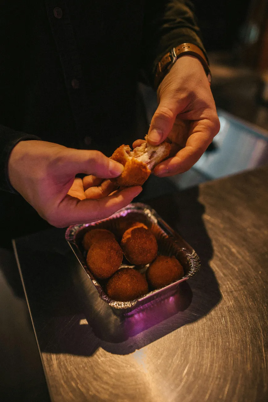 arancini being torn apart by a chef