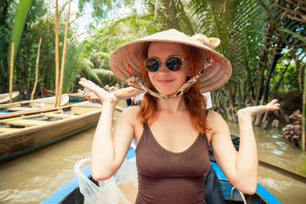 Tourist on a small boat on Mekong river — Shutterstock