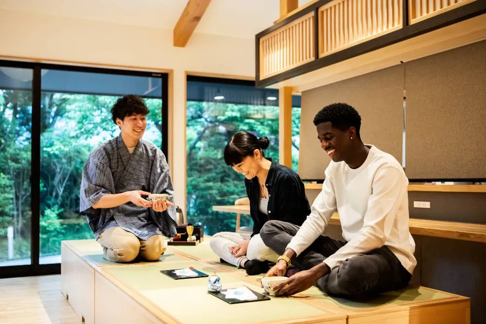People engaging in Japanese tea ceremony experience — Getty Images