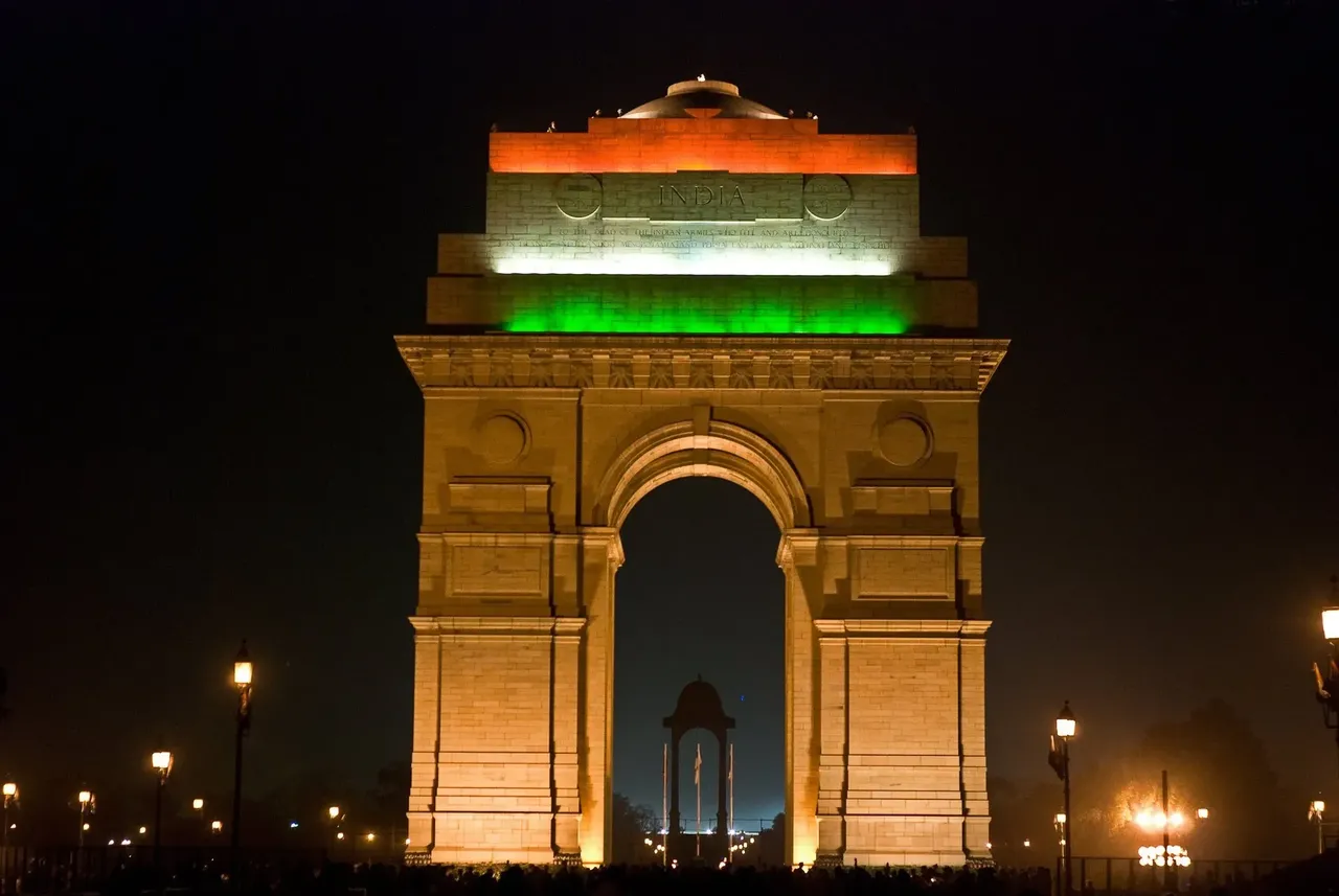 Az éjszakai égbolt kiemeli a megvilágított India kapujának ragyogását