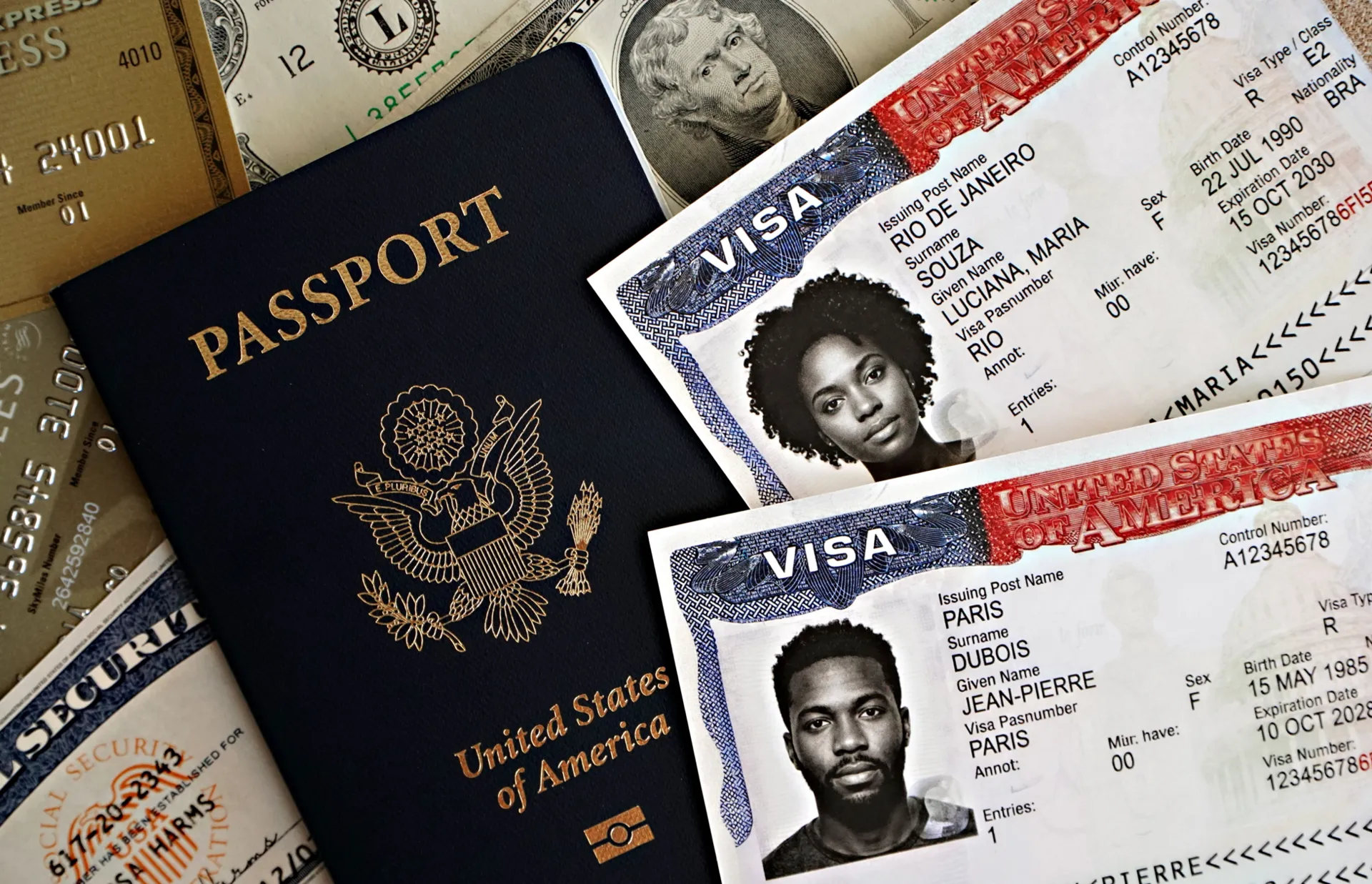 A passport and travel visas with bank cards laid out on a table
