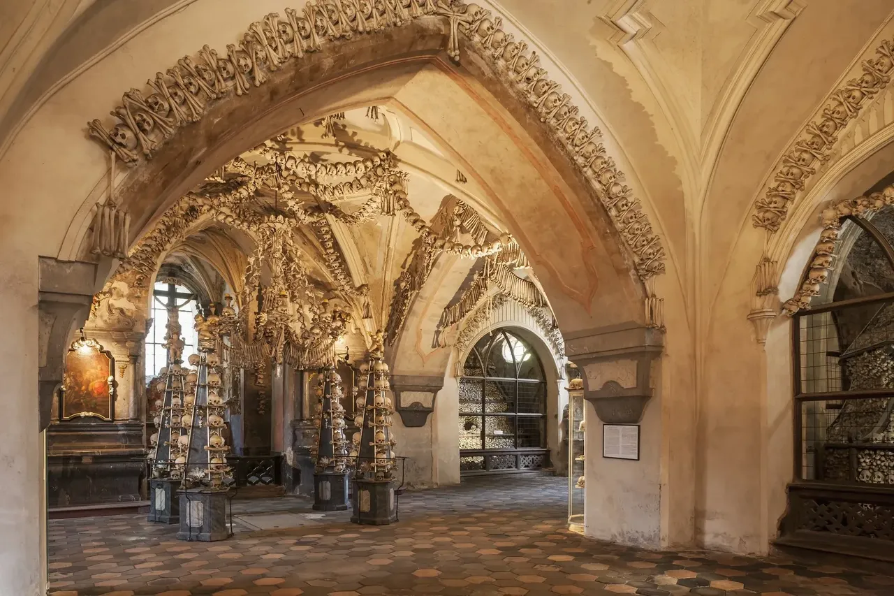 Interior of the Sedlec Ossuary featuring chandeliers and decorations made from human bones