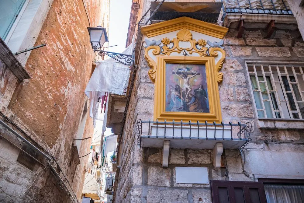 Small religious icon shrine on buildng wall in Bari — Getty Images