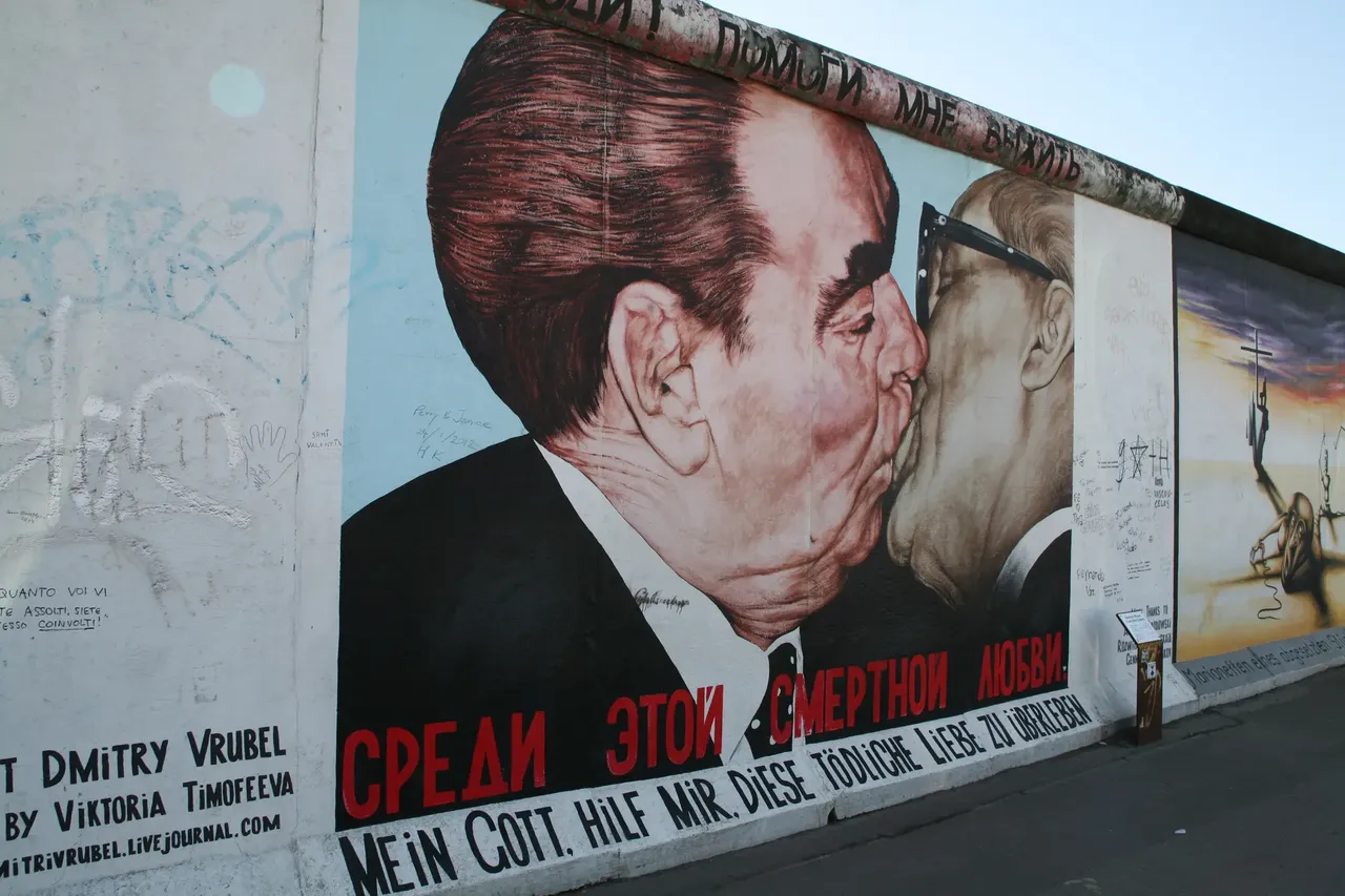 Mural painting portraying the kiss between communist leaders Leonid Brezhnev and Erich Honeckeron, on the Berlin wall, East Side Gallery, district of Friedrichshain, Berlin - Germany