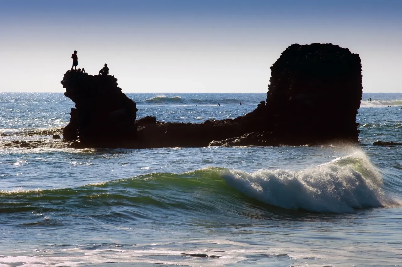 A tranquil beach scene at El Tunco in El Salvador, with gentle waves lapping against the sandy shore.