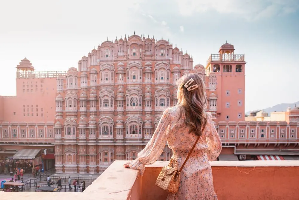 Girl on balcony looking at Hawa Mahal — Getty Images