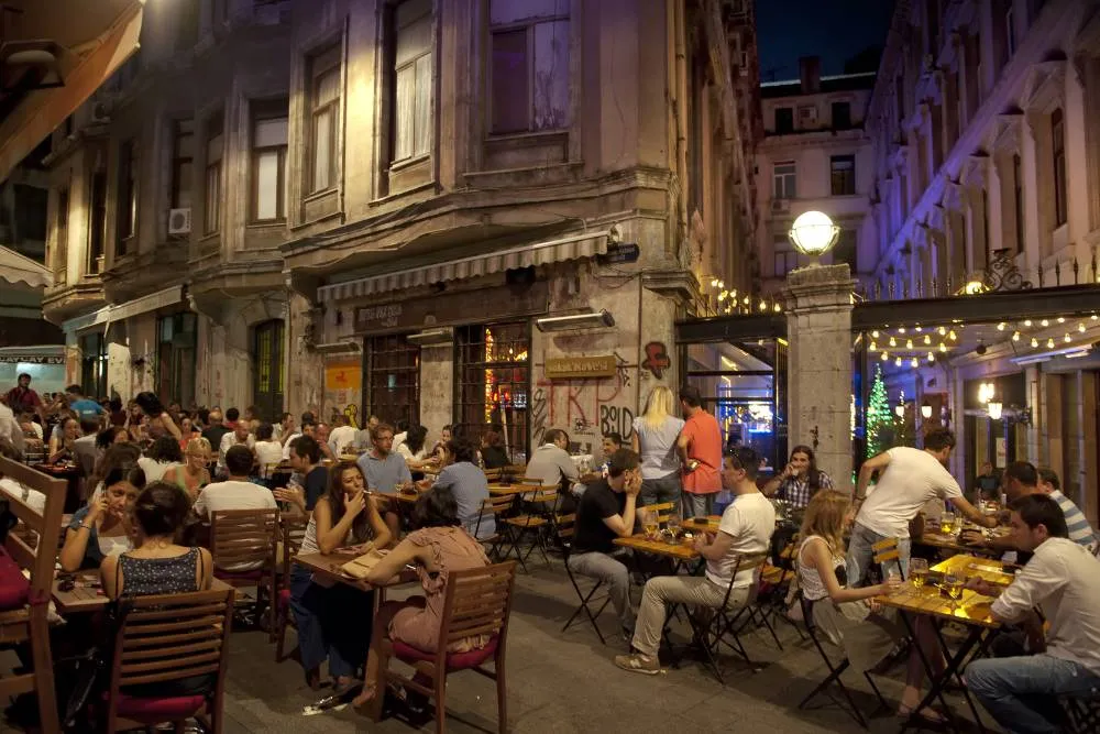 Street restaurant on Istikal Avenue in evening — Getty Images