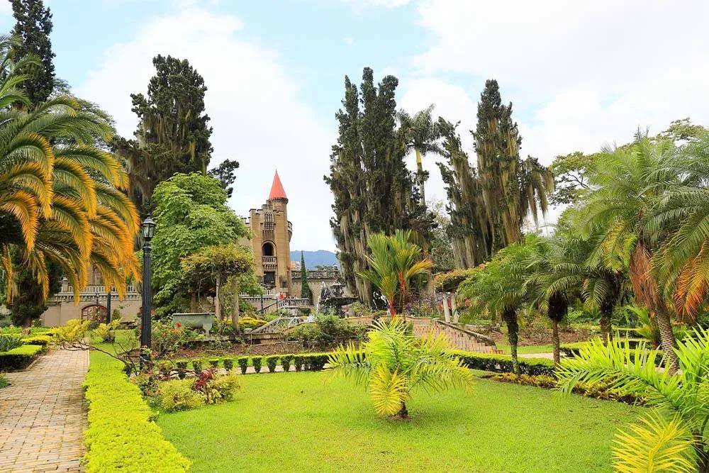 Palm trees and structures in the garden of El Castillo Museum in Medellín