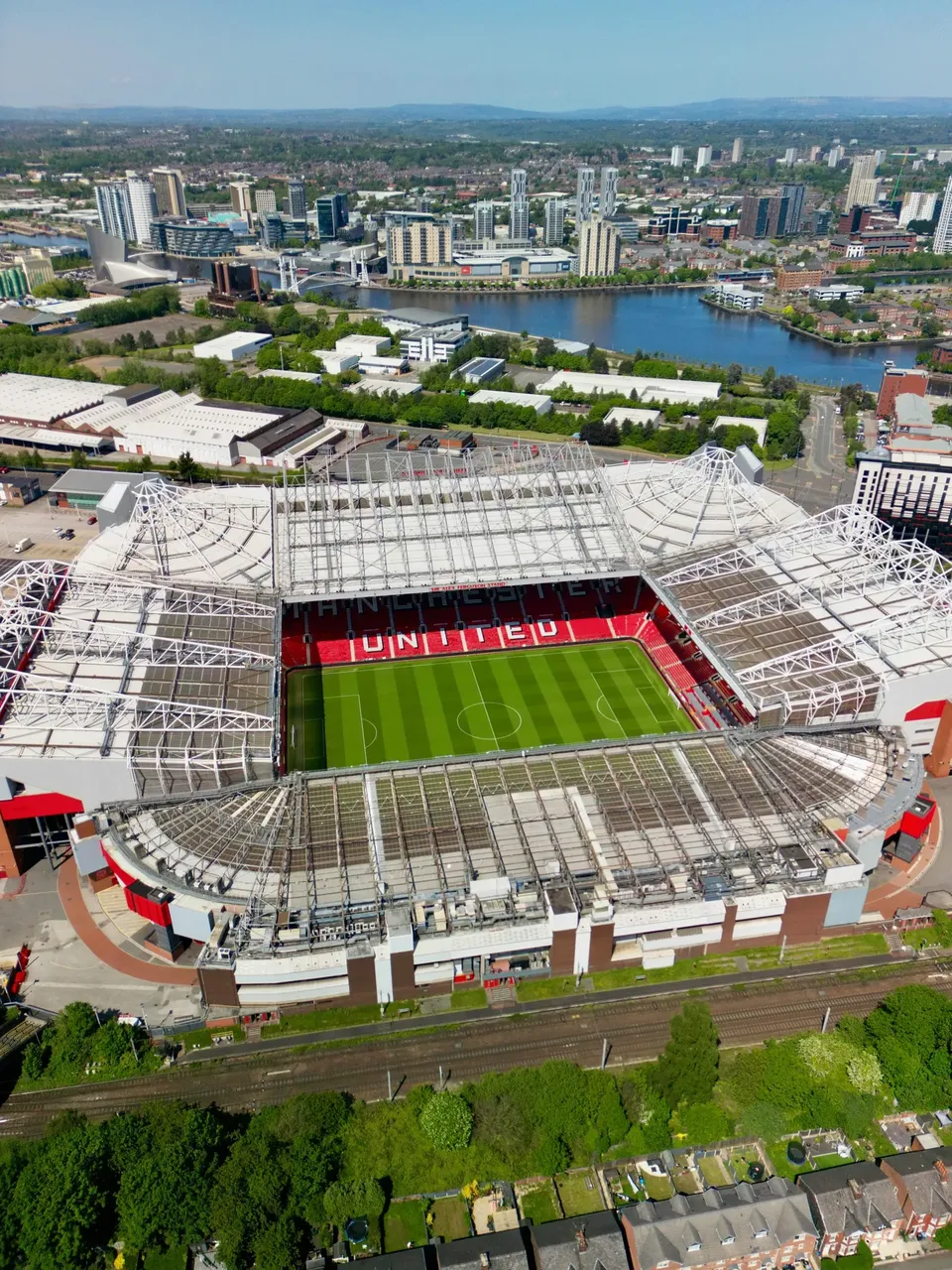 Old Trafford, the iconic Manchester United stadium, with its distinctive red seats and towering stands