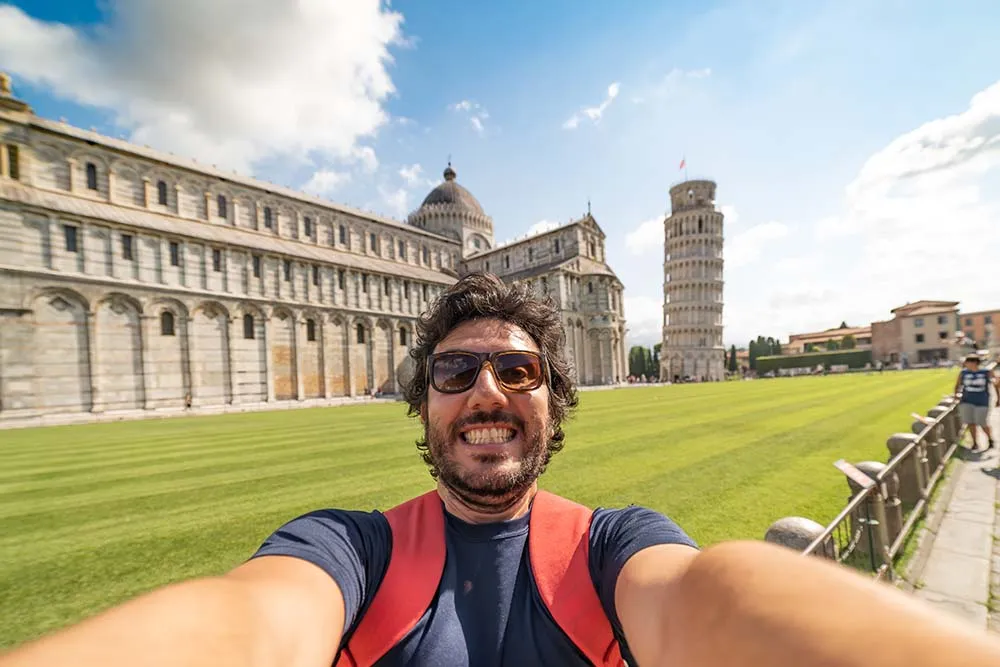 Pisa, Tuscany, happy tourist visiting the famous leaning tower