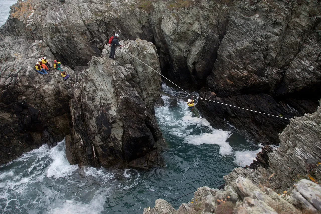 People coasteering on small cliffs — Shutterstock