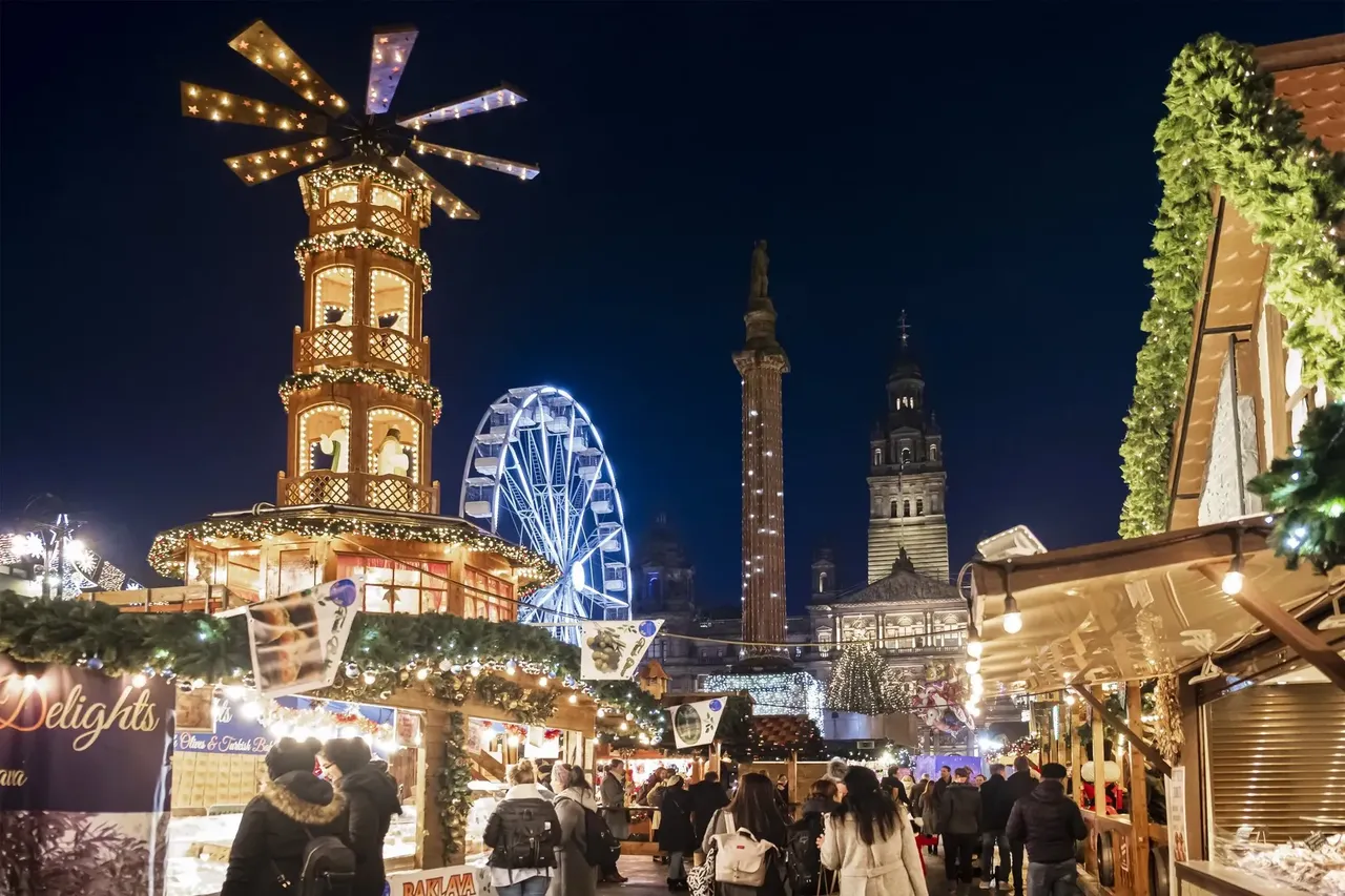 Festive stalls and twinkling lights at the Glasgow Christmas Market during the holiday season.