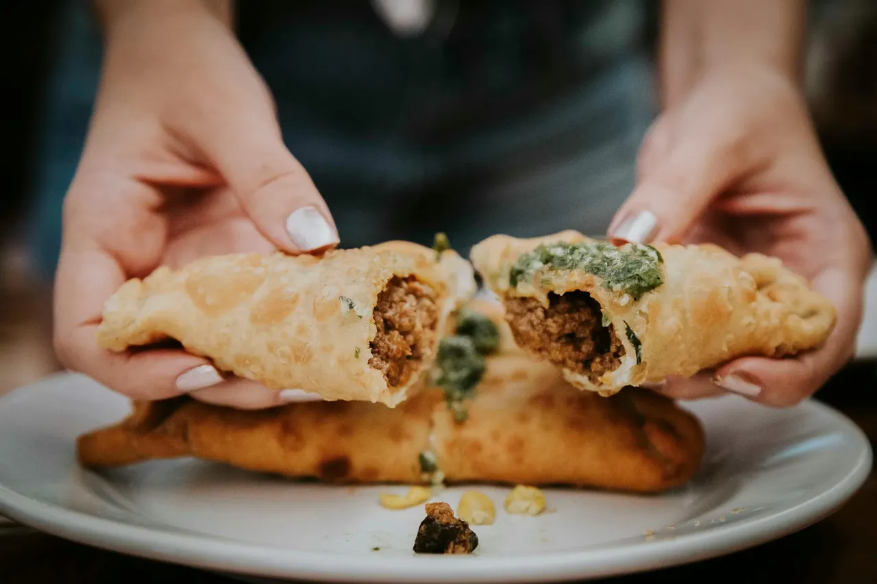 A close-up of freshly baked empanadas, golden brown and ready to eat