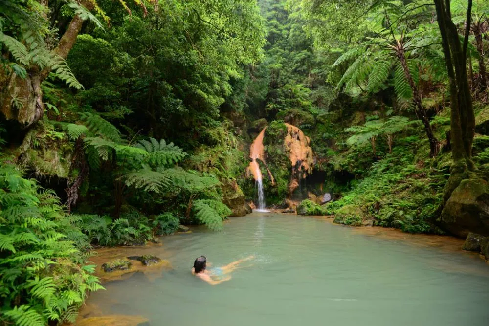 Person bathing in natural spring pool — Getty Images