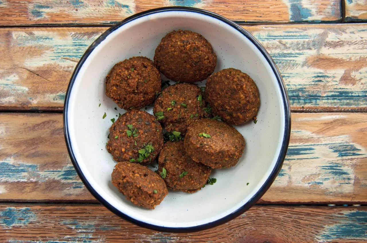 A plate of crispy, golden falafel, capturing the flavors of Jeddah’s street food scene