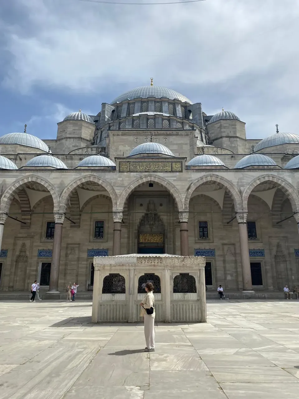 The iconic Blue Mosque in Istanbul, with its six minarets and cascading domes, set against a clear blue sky.